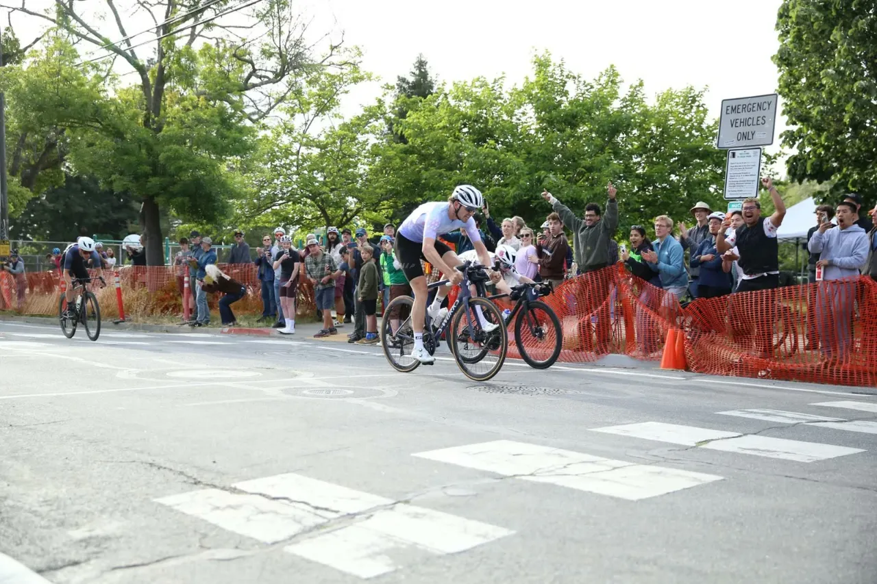 Spectators cheer as riders round a corner at the Berkeley Streets Criterium